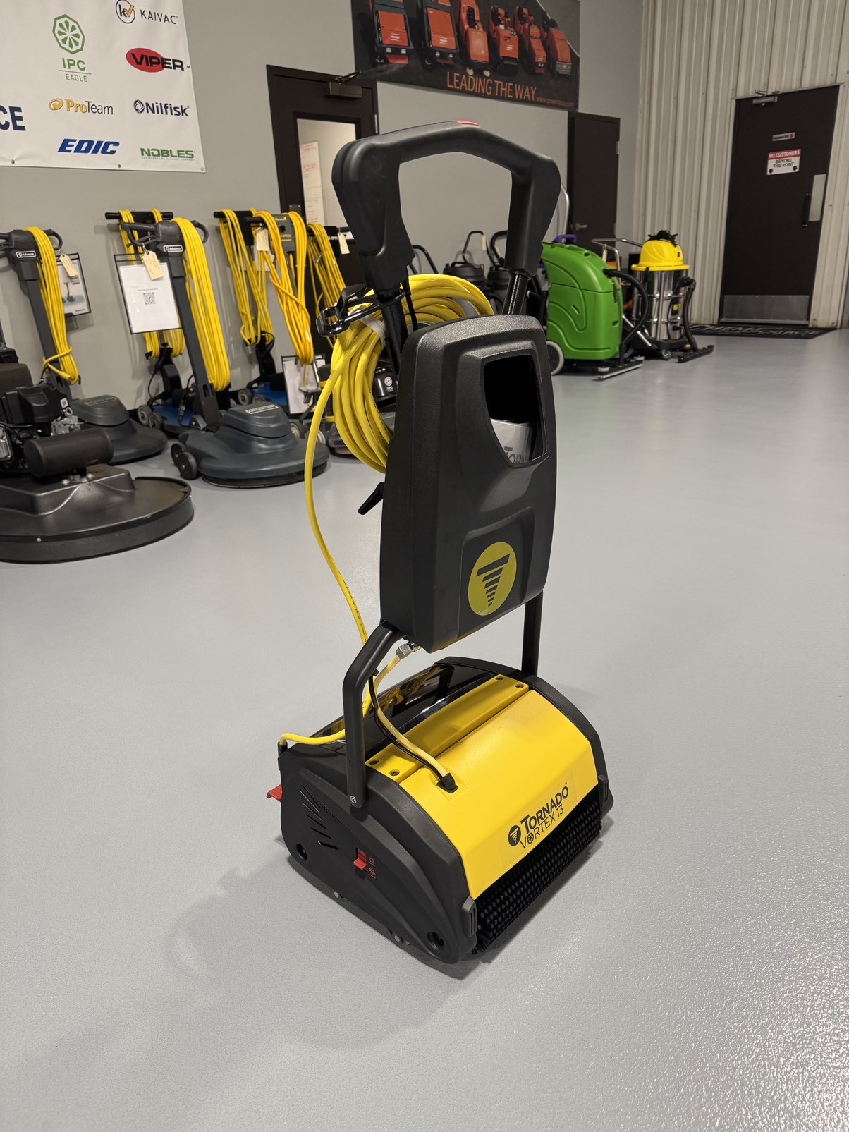 A Tornado Vortex 13 Cylindrical Floor Scrubber in a warehouse showroom at ChemSource Direct.