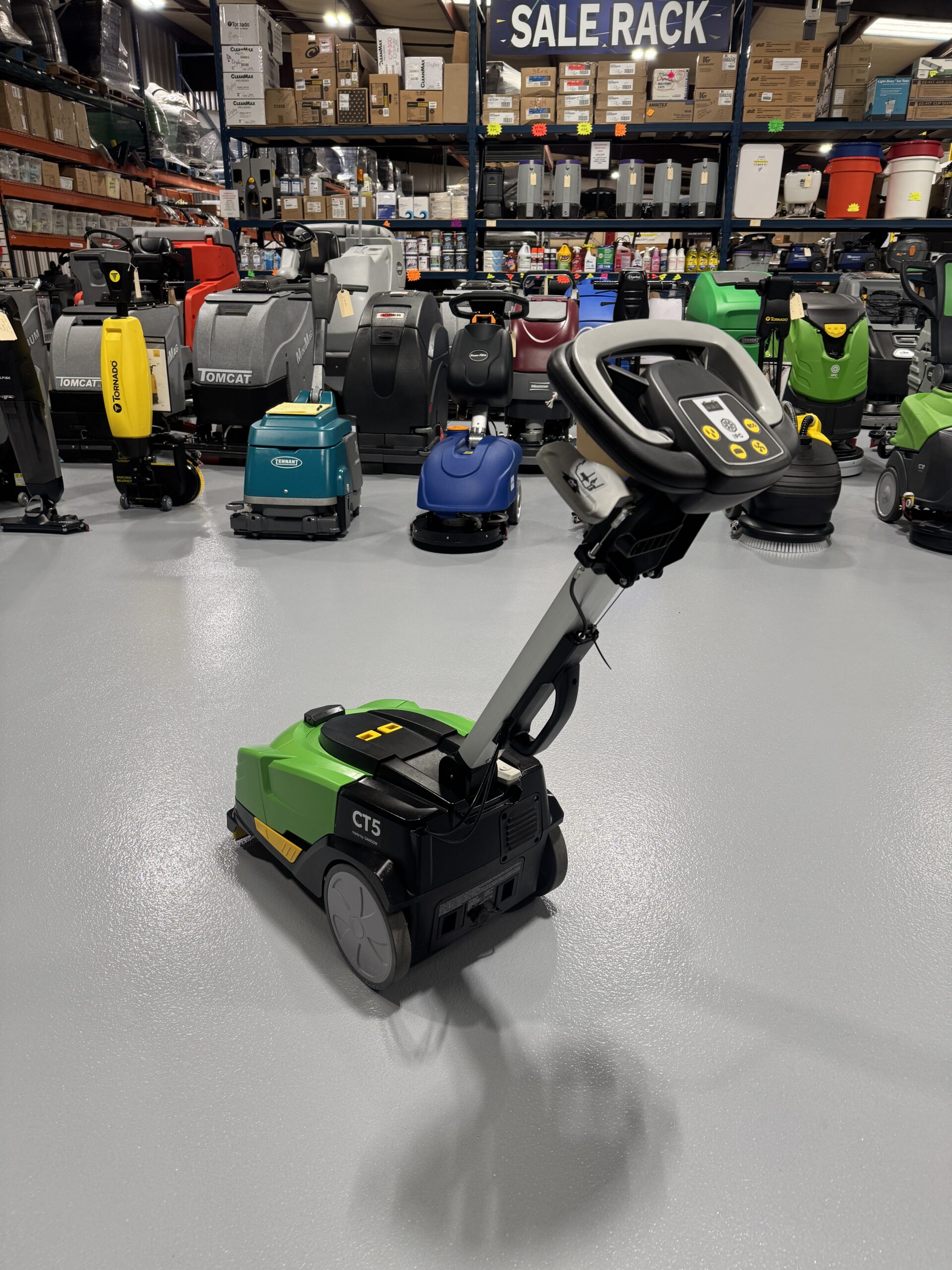 An IPC CT-5 Mini Floor Scrubber in a warehouse showroom at ChemSource Direct.