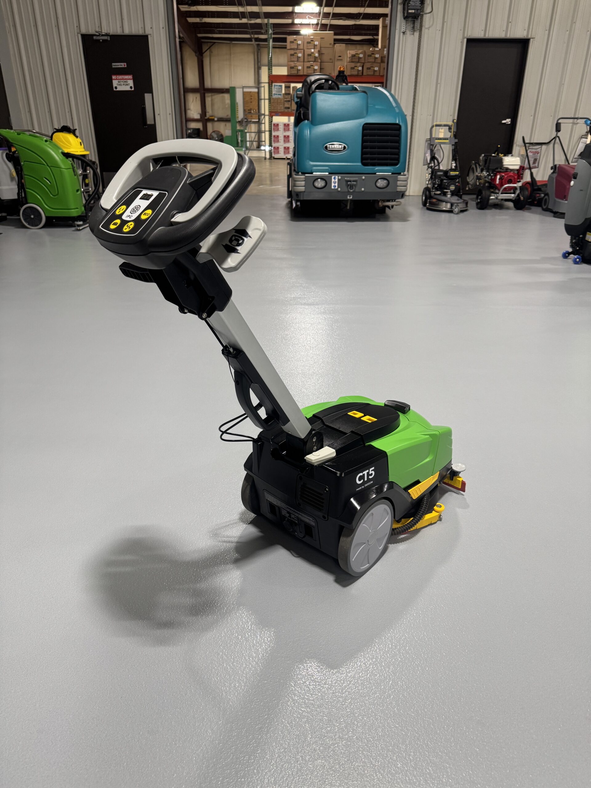 An IPC CT-5 Mini Floor Scrubber in a warehouse showroom at ChemSource Direct.