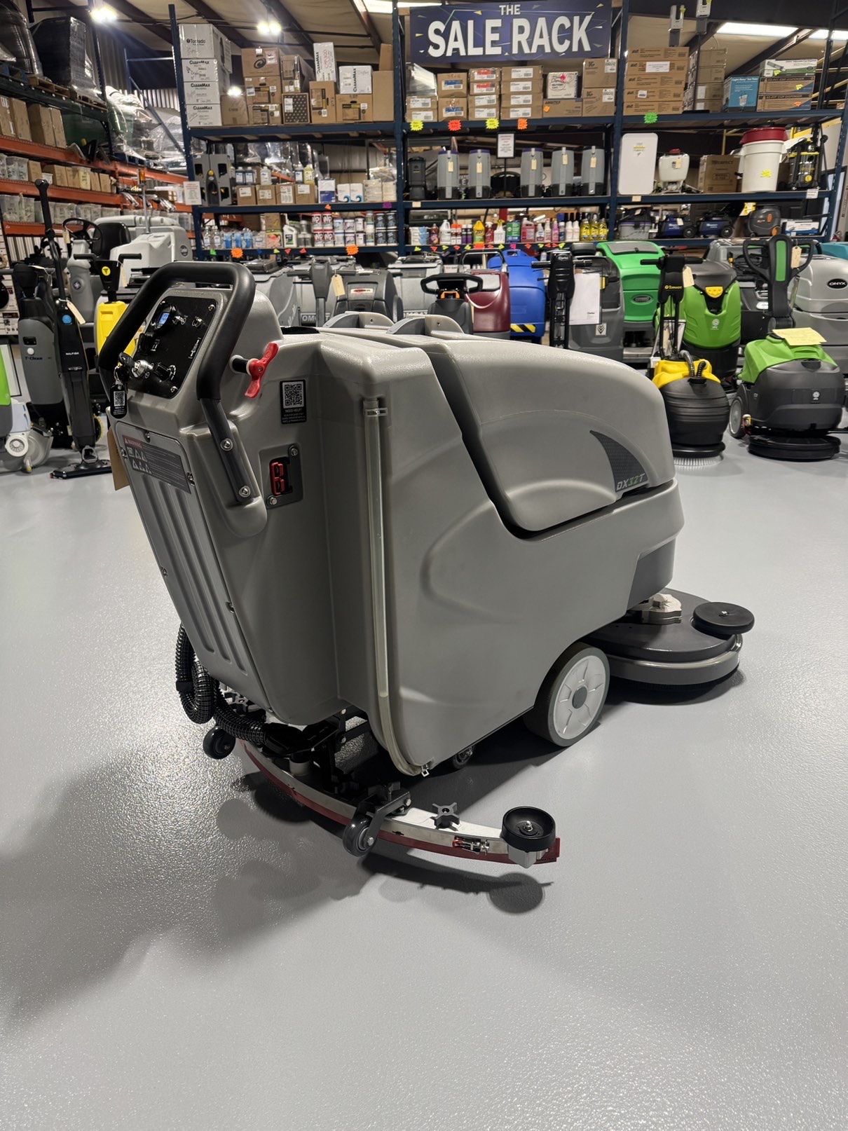 An Onyx DX32T Walk-Behind Scrubber in a warehouse showroom at ChemSource Direct.