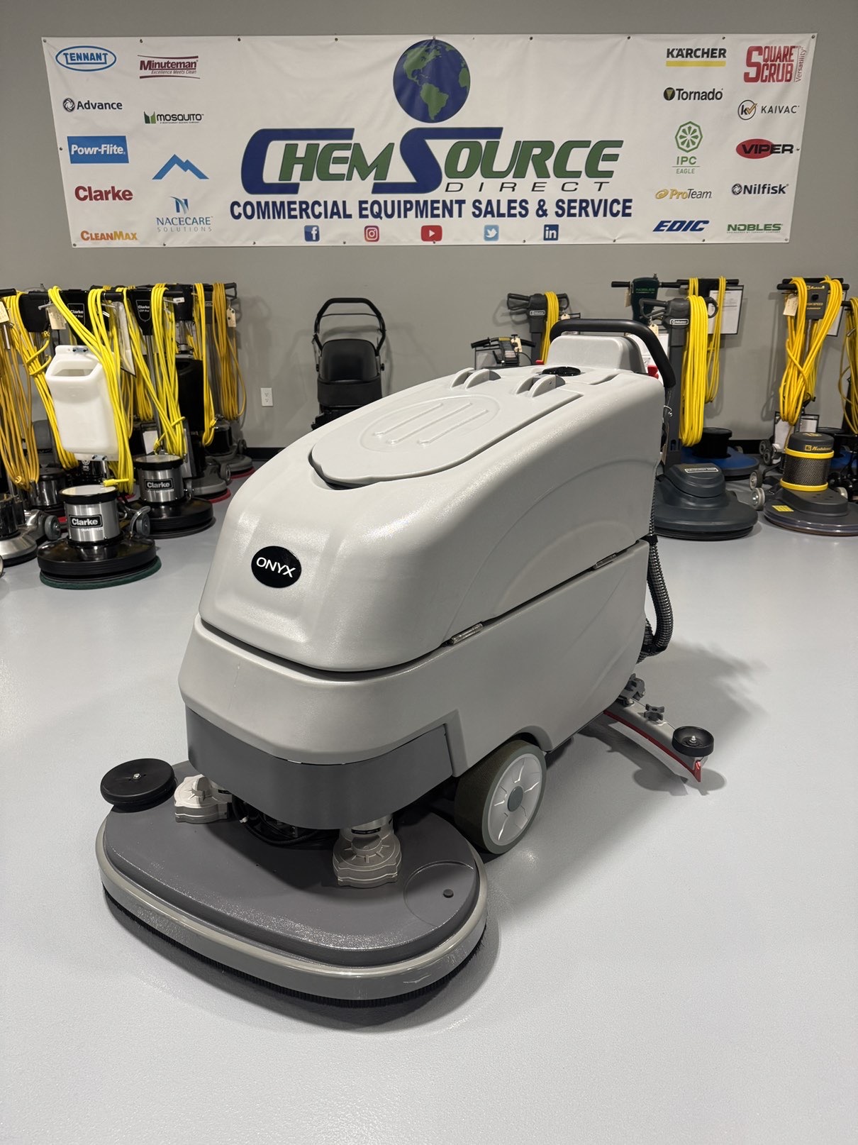 An Onyx DX32T Walk-Behind Scrubber in a warehouse showroom at ChemSource Direct.