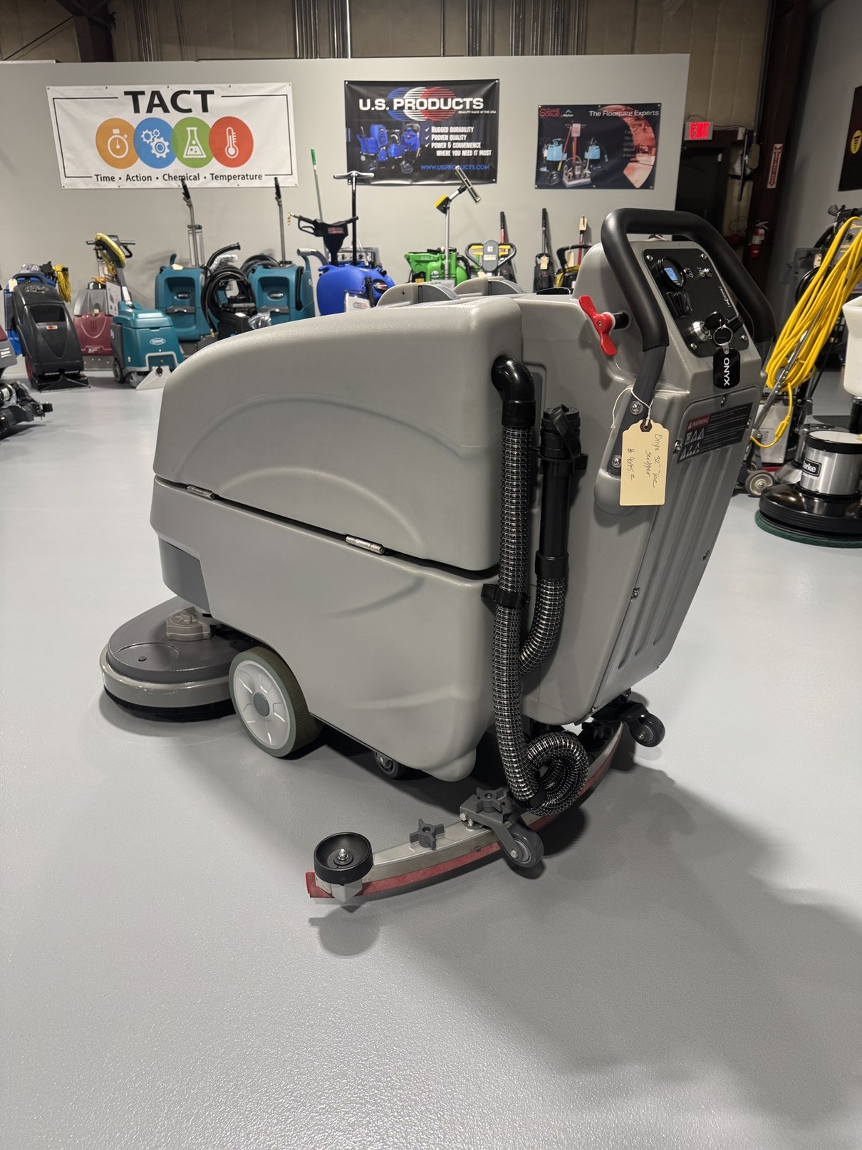 An Onyx DX32T Walk-Behind Scrubber in a warehouse showroom at ChemSource Direct.