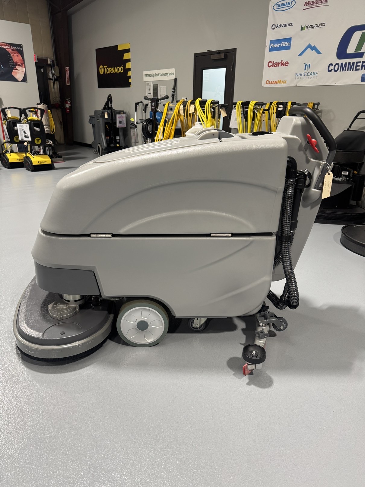 An Onyx DX32T Walk-Behind Scrubber in a warehouse showroom at ChemSource Direct.