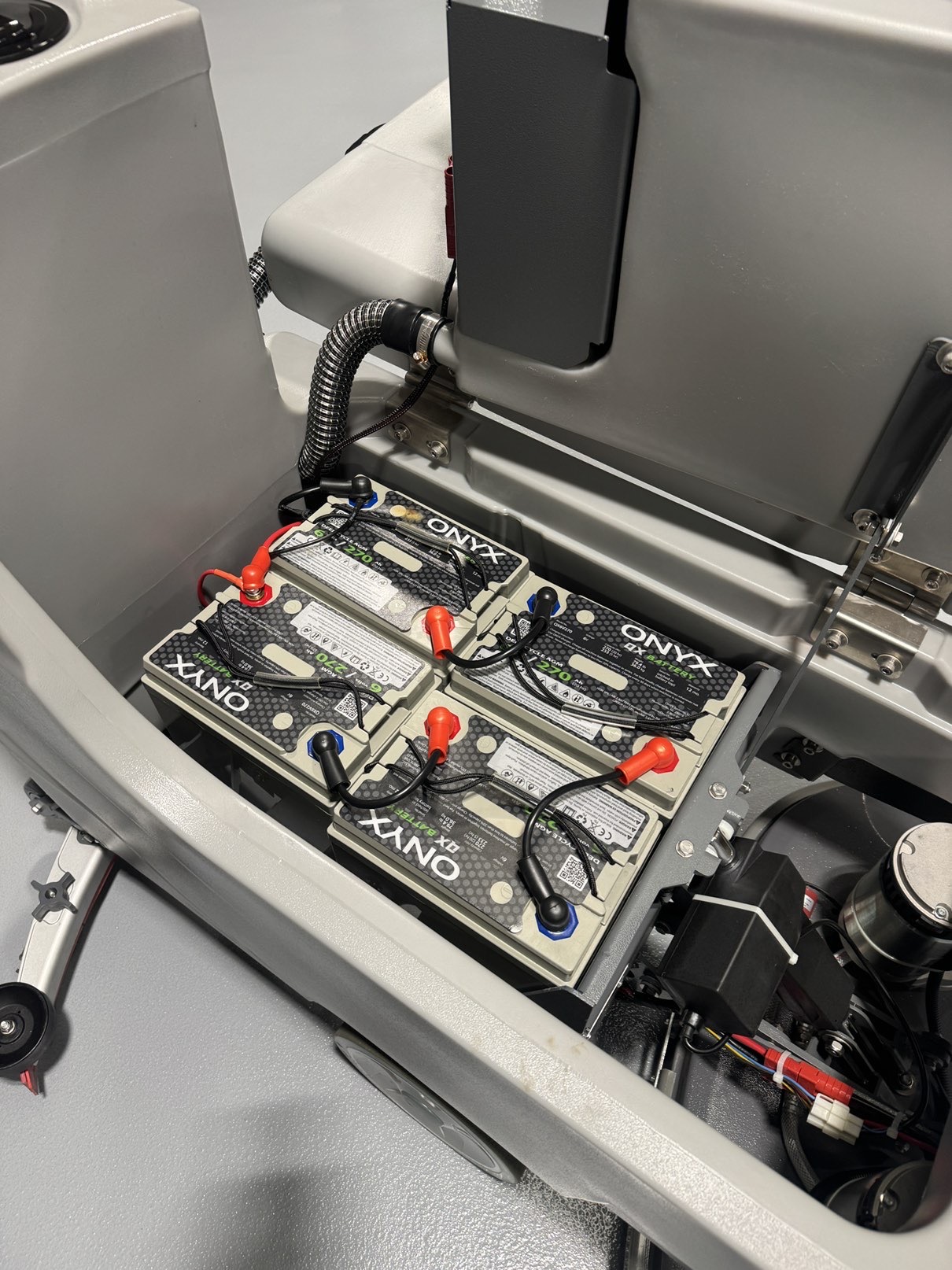 An Onyx DX32T Walk-Behind Scrubber in a warehouse showroom at ChemSource Direct.