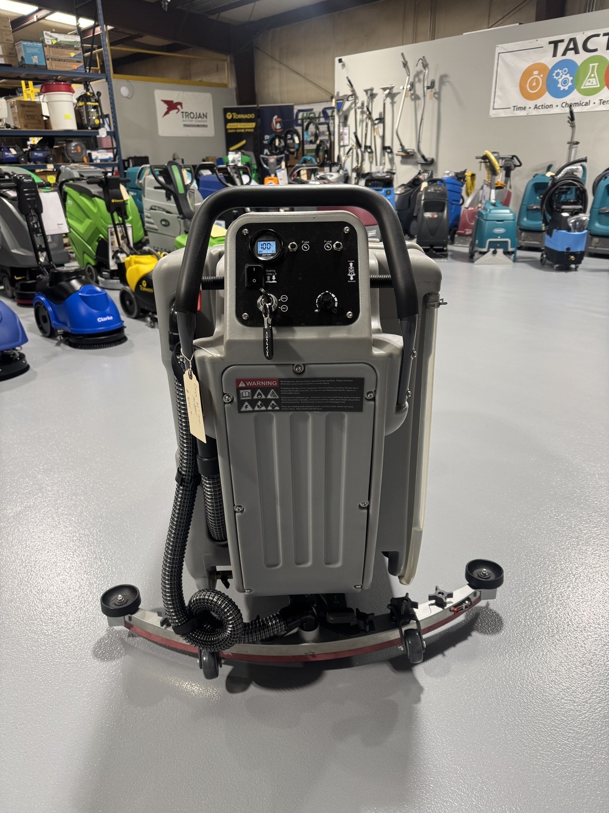 An Onyx DX32T Walk-Behind Scrubber in a warehouse showroom at ChemSource Direct.