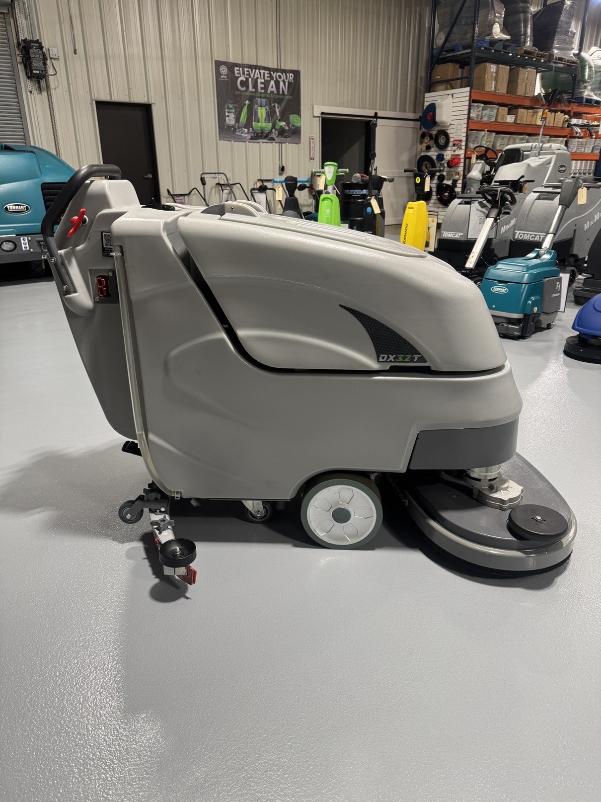 An Onyx DX32T Walk-Behind Scrubber in a warehouse showroom at ChemSource Direct.