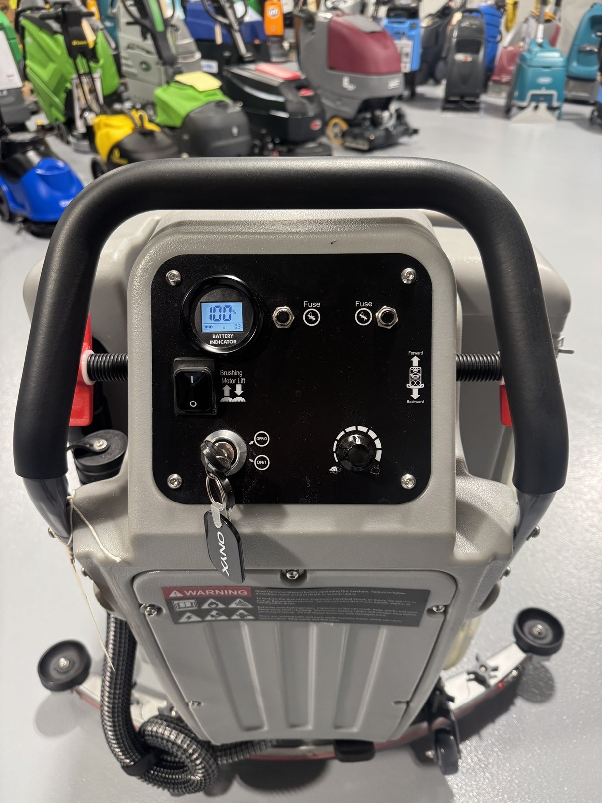 An Onyx DX32T Walk-Behind Scrubber in a warehouse showroom at ChemSource Direct.