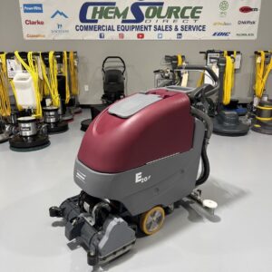 A Minuteman E20CQP Walk-Behind Scrubber in a warehouse showroom at ChemSource Direct.