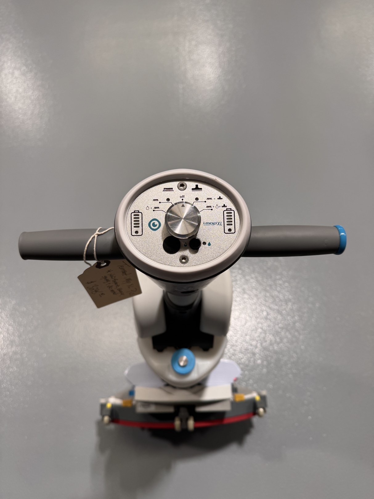 A Tennant iMop XL Plus Walk-Behind Scrubber in a warehouse showroom at ChemSource Direct.