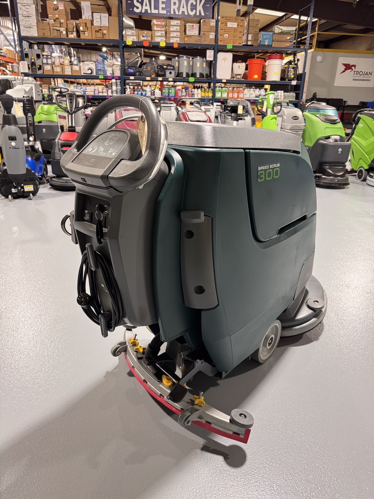 A Nobles SpeedScrub 300 Walk-Behind Scrubber in a warehouse showroom at ChemSource Direct.