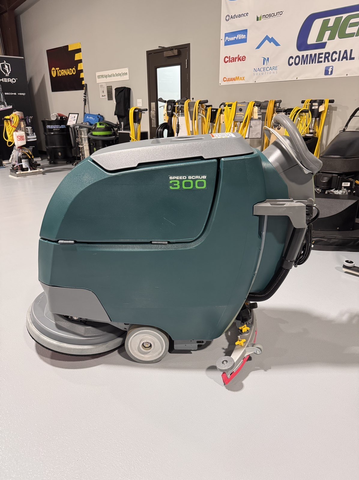 A Nobles SpeedScrub 300 Walk-Behind Scrubber in a warehouse showroom at ChemSource Direct.