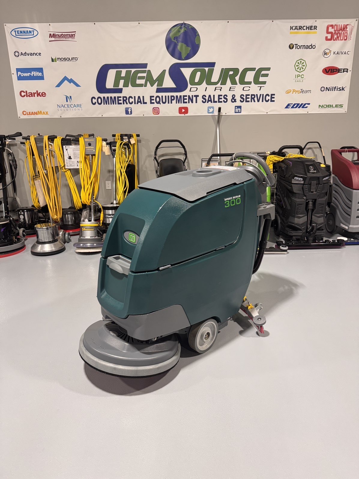 A Nobles SpeedScrub 300 Walk-Behind Scrubber in a warehouse showroom at ChemSource Direct.