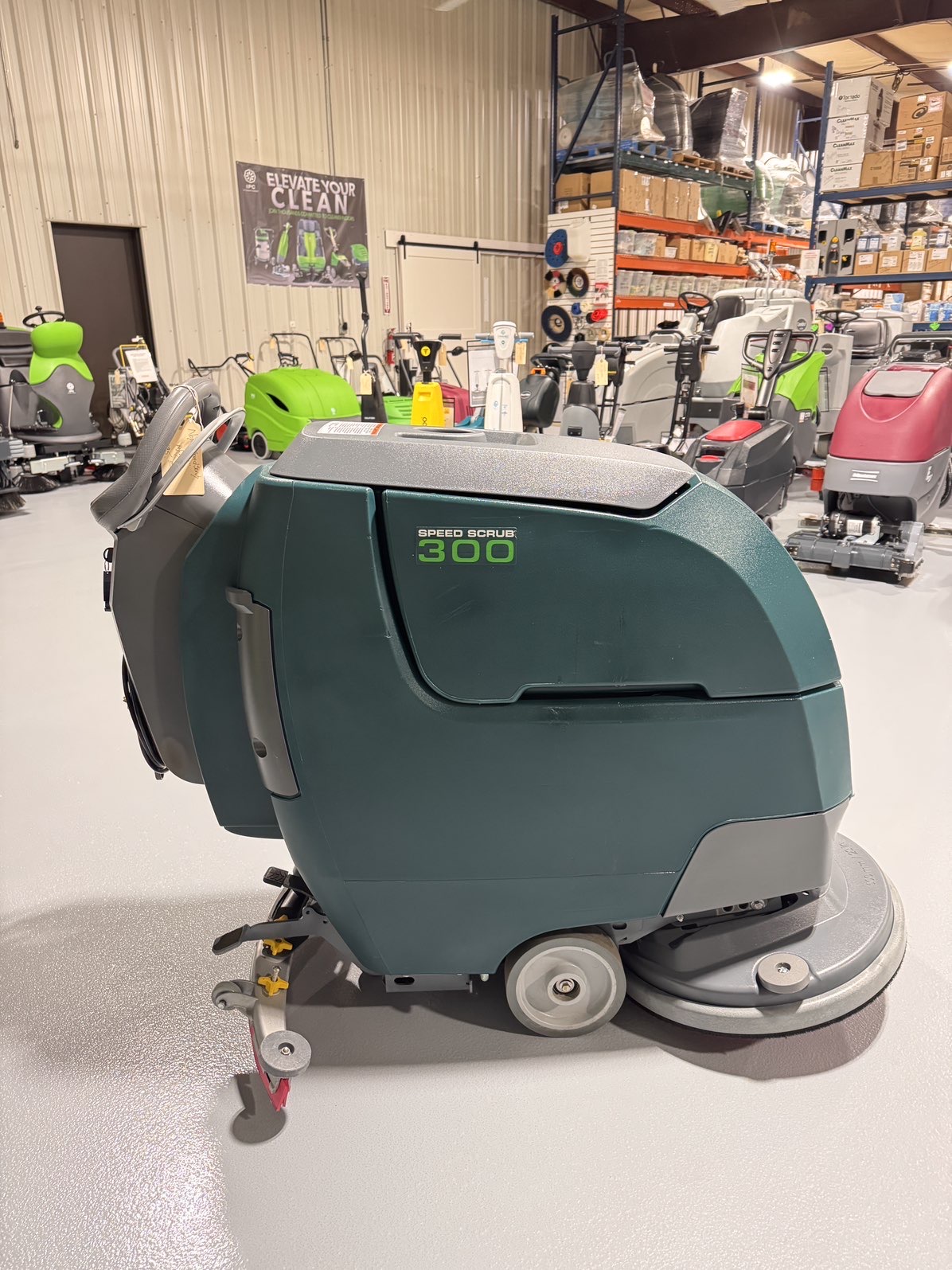 A Nobles SpeedScrub 300 Walk-Behind Scrubber in a warehouse showroom at ChemSource Direct.
