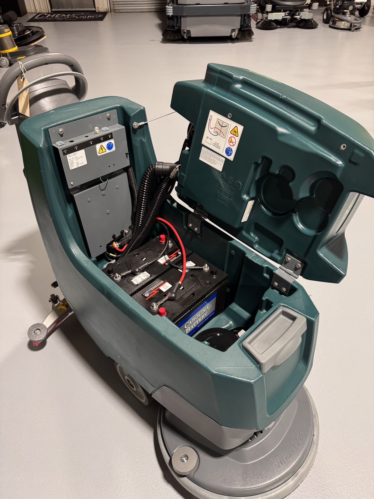 A Nobles SpeedScrub 300 Walk-Behind Scrubber in a warehouse showroom at ChemSource Direct.