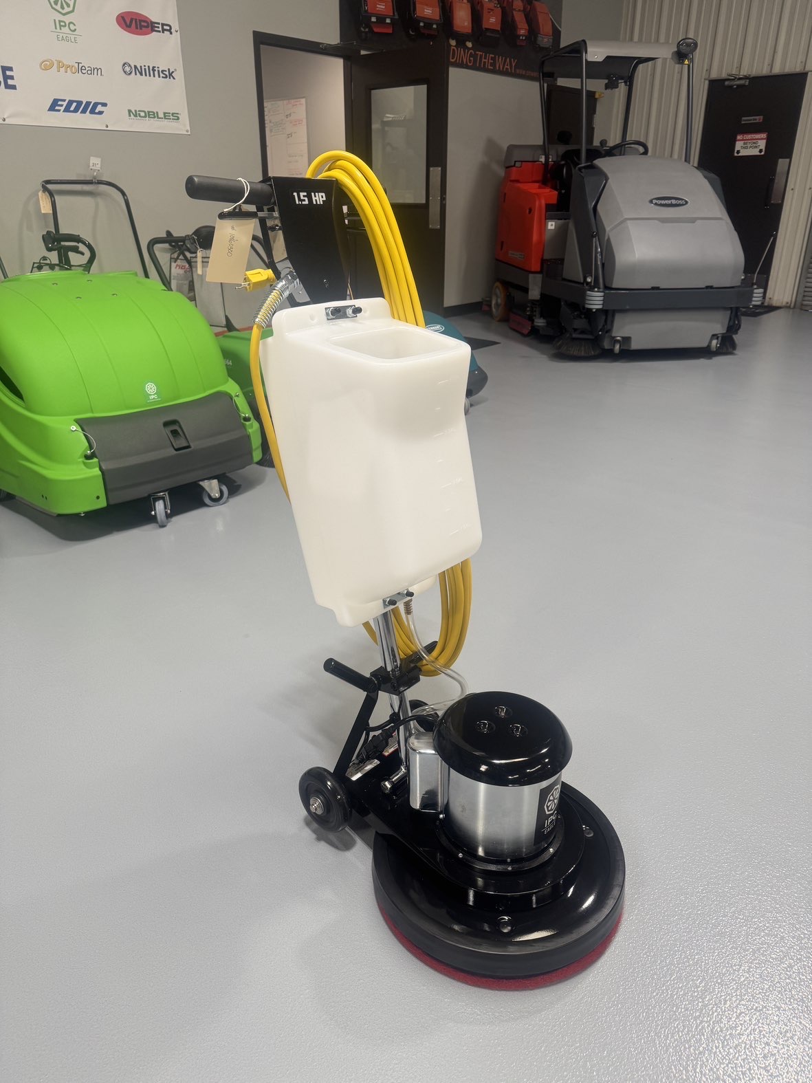 An IPC FM17 HD Low Speed Scrubber with Tank in a warehouse showroom at ChemSource Direct.