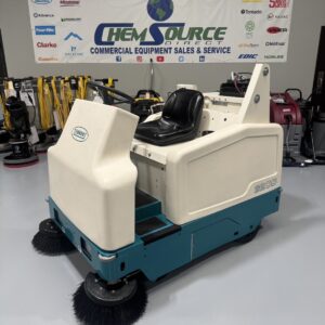 A Tennant 6200 Ride-On Sweeper in a warehouse showroom at ChemSource Direct.